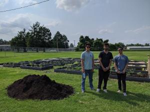 Volunteers helping weed, prep, and plant at the LaLumier Elementary School community garden beds. 