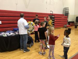 Children attending the Belle Valley School 's Family Fit Night lined up for a chance to test their knowledge on various health & wellness topics and earn a prize from the HEALTHIER TOGETHER booth. 