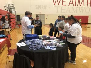 HEALTHIER TOGETHER's Executive Director, Mark Peter's helping the McKendree student volunteers educate families on various health & wellness topics. 